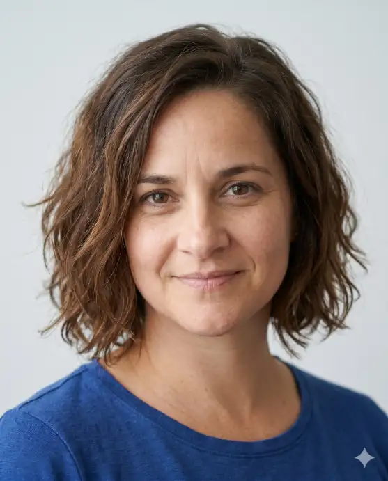Create a realistic portrait using the uploaded photo, keeping the face and features identical. Change only the hairstyle to a choppy bob with textured waves ending around the jaw, with a tousled, lived-in finish. The color is a natural medium brown. The person is angled slightly with a cool, relaxed expression. Use eye-level framing with soft daylight and a clean background. Keep the face unchanged and the result photorealistic. Use aspect ratio 4:5.