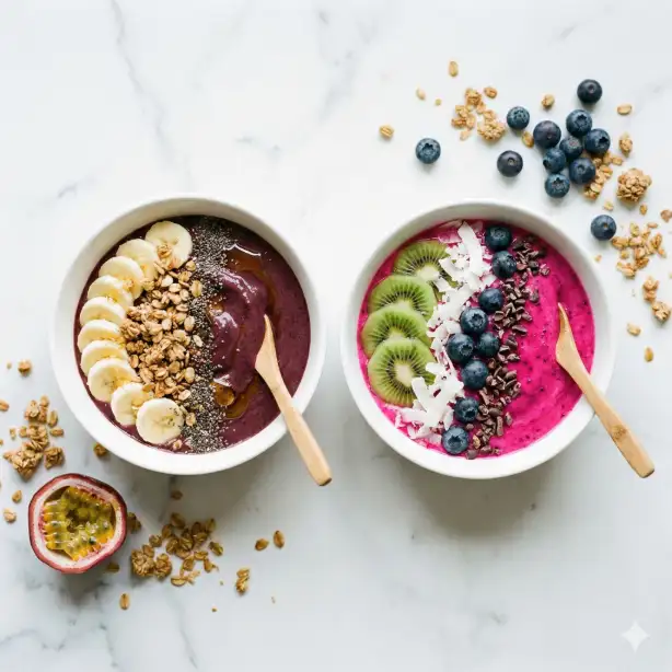 Create a realistic overhead photo of two smoothie bowls placed side by side on a white marble countertop. The left bowl is a vibrant deep purple acai blend topped with sliced banana, granola clusters, chia seeds, and a drizzle of honey. The right bowl is a bright pink dragon fruit blend topped with kiwi slices, shredded coconut, fresh blueberries, and cacao nibs. Both bowls are in smooth white ceramic dishes. A small wooden spoon rests in each bowl. Surrounding the bowls are scattered ingredients including loose granola, a few blueberries, and a half-cut passion fruit. The camera is directly overhead. Bright, clean natural light with soft shadows, giving it a fresh and airy feel. Vibrant, saturated color palette. Shot with a 35mm lens. Use aspect ratio 1:1.