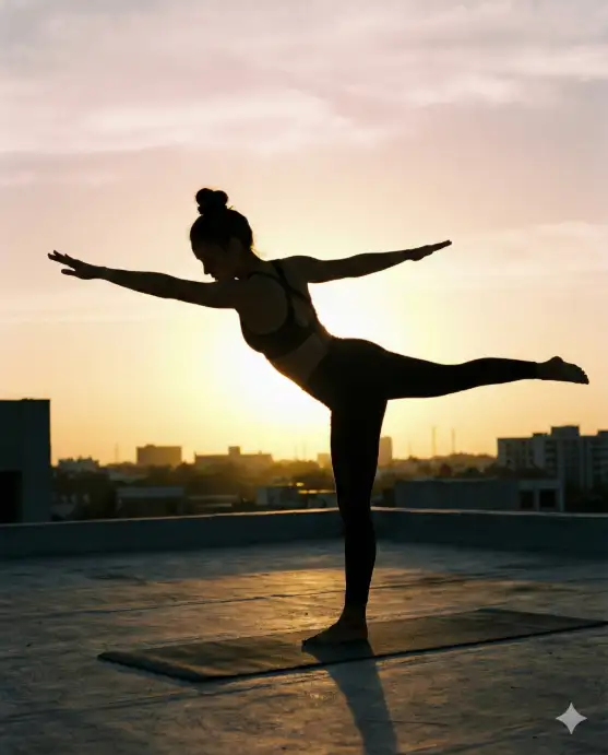 Create a silhouette photo of a young woman in a warrior pose on a rooftop at sunrise, standing on a yoga mat with her arms extended wide and one leg stretched behind her. She is wearing a fitted sports bra and high-waisted leggings with her hair tied up in a high bun. The early morning sun is rising directly behind her, creating a bright golden glow around her entire body outline. The rooftop is flat and clean with a simple concrete surface, and the city skyline is visible in the soft background as dark shapes against the bright sky. The camera is at ground level, shooting upward slightly to make her figure appear powerful against the sky. Warm golden and soft pink tones, minimal composition, wellness aesthetic. Shot with a 35mm lens. Use aspect ratio 4:5.