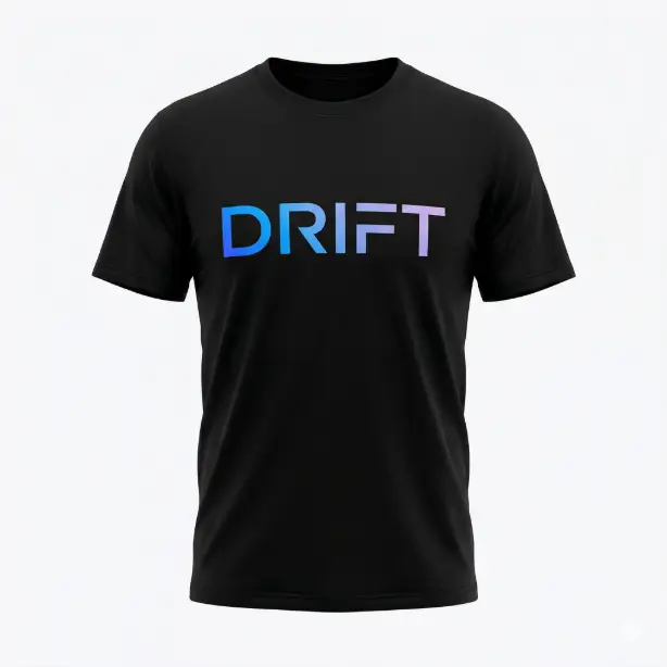Create a product photo of a black t-shirt on a clean white backdrop, displayed on an invisible mannequin so the shirt holds its shape. The shirt features the word "DRIFT" in large, wide-set uppercase letters with a smooth horizontal gradient that transitions from electric blue on the left to soft lavender on the right. The font is a geometric sans-serif with consistent stroke width. The gradient is perfectly smooth and the print quality looks high-end and precise. The camera is straight on at chest height. Bright, clean, diffused studio lighting with no shadows. Sleek, modern, contemporary graphic design product photography style. Use aspect ratio 1:1.