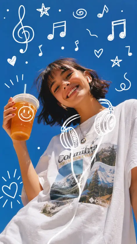Create a cheerful low-angle photo of a young woman leaning into the frame against a clear blue sky, smiling widely with her head tilted. She has short dark hair with wispy bangs, wireless earbuds in her ears, and holds up a cup of iced orange tea near her shoulder. She wears an oversized white t-shirt printed with small landscape photos and outdoor-brand style text, with a pendant necklace. Bright direct sunlight with vivid, saturated colors. Cover the sky around her with hand-drawn white doodle overlays: music notes of different sizes, a treble clef, stars, hearts, swirls, sketched headphones resting around her shoulders, and a smiley face drawn on the drink cup. Fun, energetic, playlist-cover energy. Use aspect ratio 9:16.