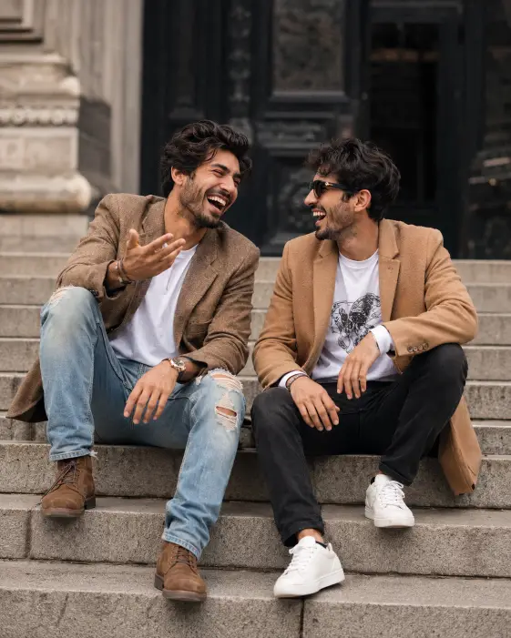 Two Friends Laughing on City Steps